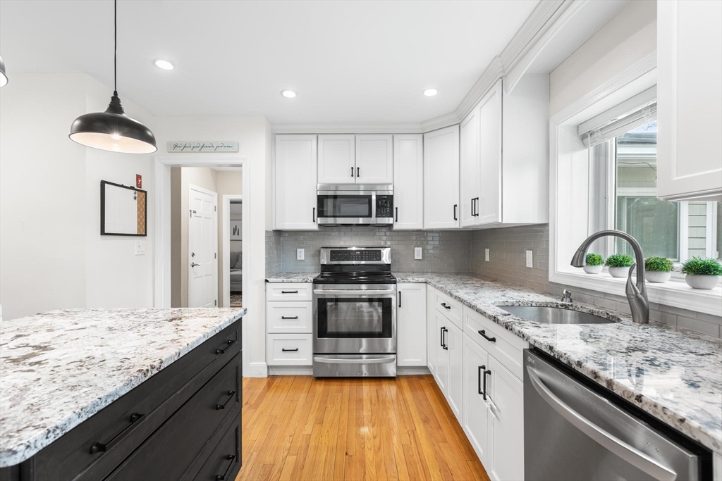 89 Haggetts Pond Road Andover, MA 01810 - Photo 7 of 42 a large kitchen with granite countertop a stove and a sink