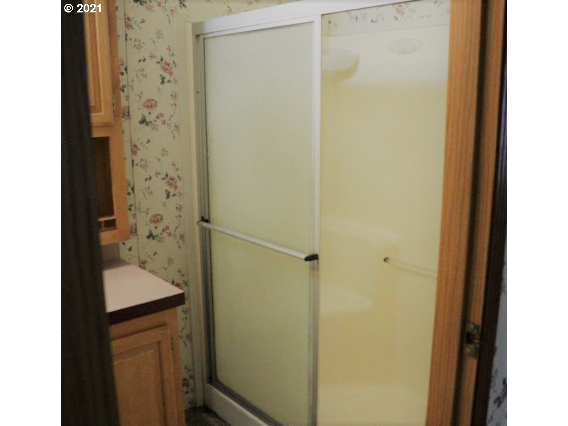 2150 Laura Street, Unit 221 Springfield, OR 97477 - Photo 14 of 16 a bathroom with a shower and a sink