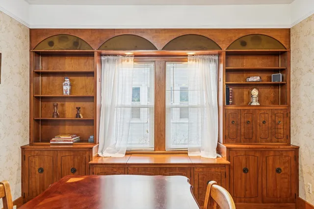 a dining room with furniture window and wooden floor
