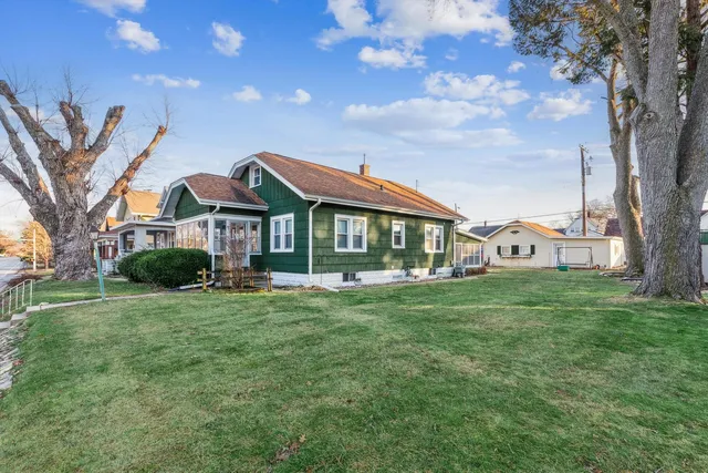 a front view of a house with a garden