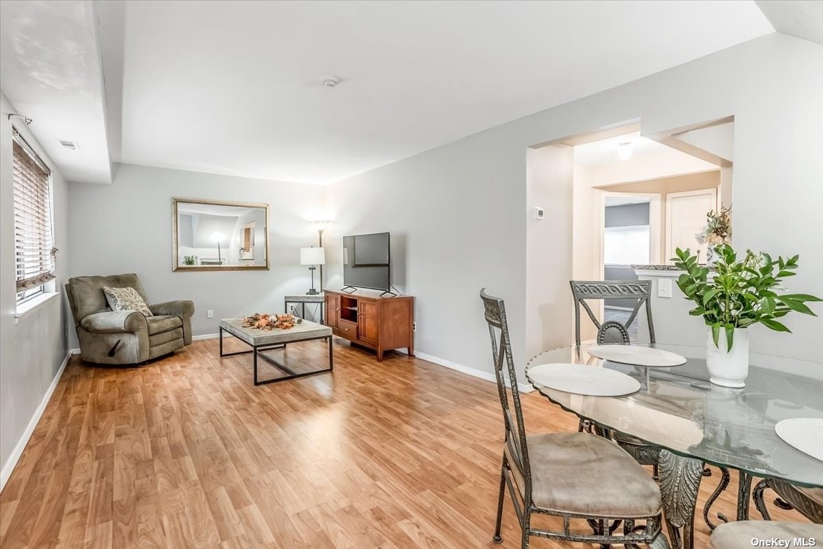 89 Pointe Circle South, Unit 89 Coram, NY 11727 - Photo 1 of 1 a living room with furniture and wooden floor
