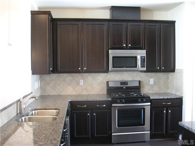 9134 Falkwood Road, Unit 175 Raleigh, NC 27617 - Photo 4 of 14 Granite, gas range and 42" maple Kona cabinets.