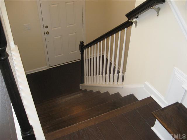 9134 Falkwood Road, Unit 175 Raleigh, NC 27617 - Photo 8 of 14 Stained oak treads with open railing.