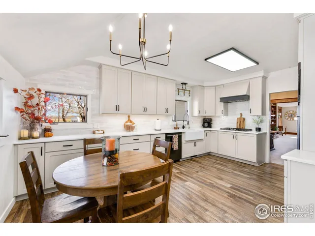 a living room with furniture a fireplace and a large window