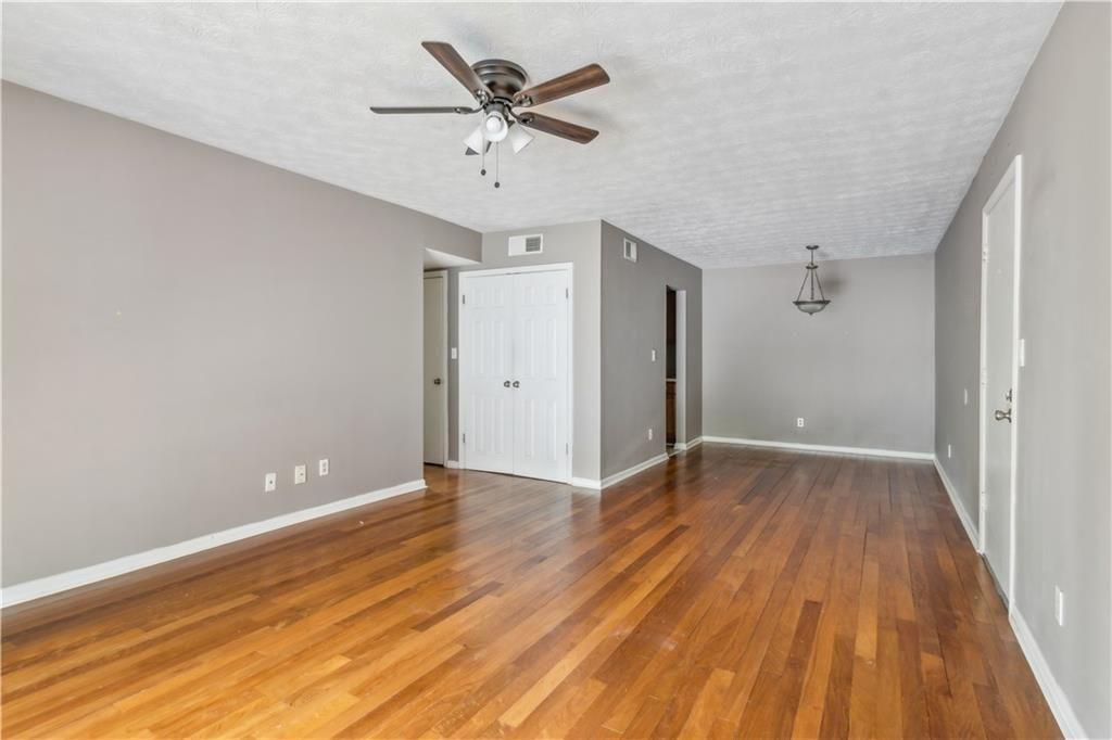 3155 Seven Pines, Unit 303 Atlanta, GA 30339 - Photo 6 of 25 wooden floor in an empty room with a window