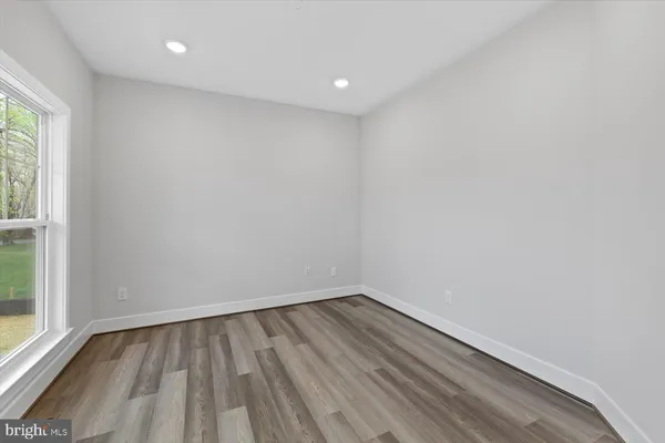 a view of room with window and wooden floor