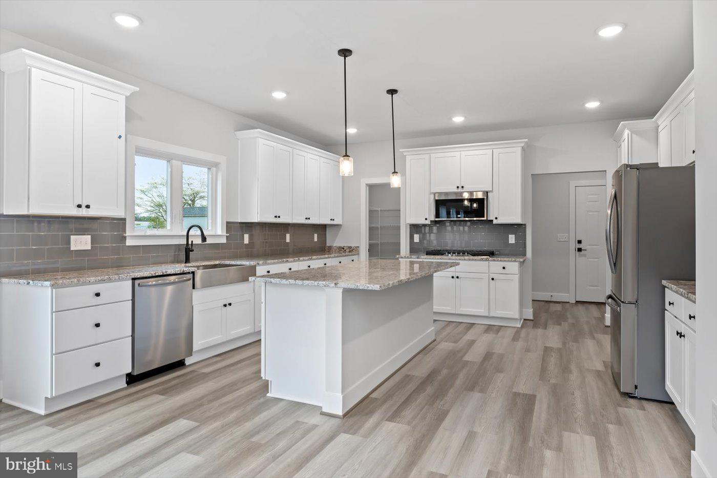 0 Stevensburg Road Culpeper, VA 22701 - Photo 15 of 42 a large kitchen with stainless steel appliances sink a microwave and cabinets