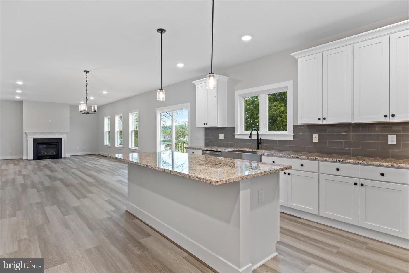 0 Stevensburg Road Culpeper, VA 22701 - Photo 17 of 42 a large kitchen with granite countertop a stove a sink a center island and wooden floor