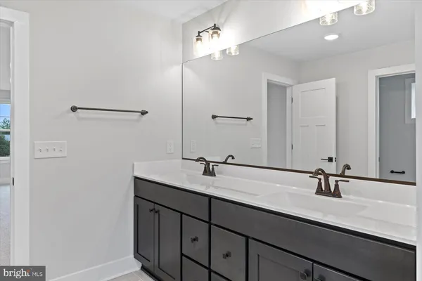 a bathroom with a double vanity sink and a mirror