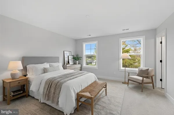 a bedroom with a bed and a couch