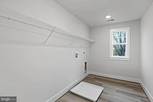 a view of a room with wooden floor and white walls