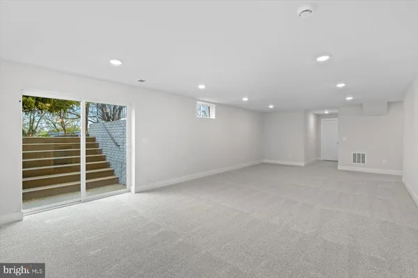 a view of an empty room with a fireplace