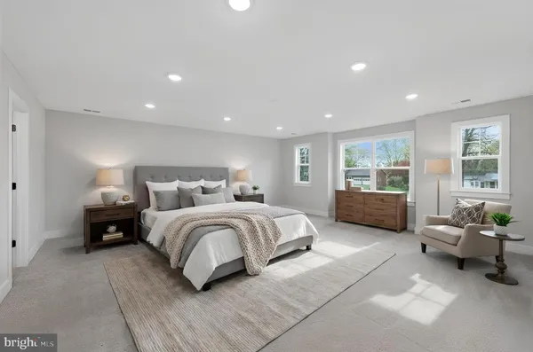 a spacious bedroom with a large bed and a couch