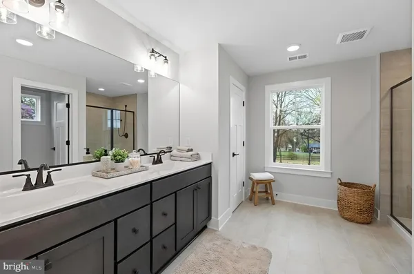 a bathroom with a double vanity sink and a mirror