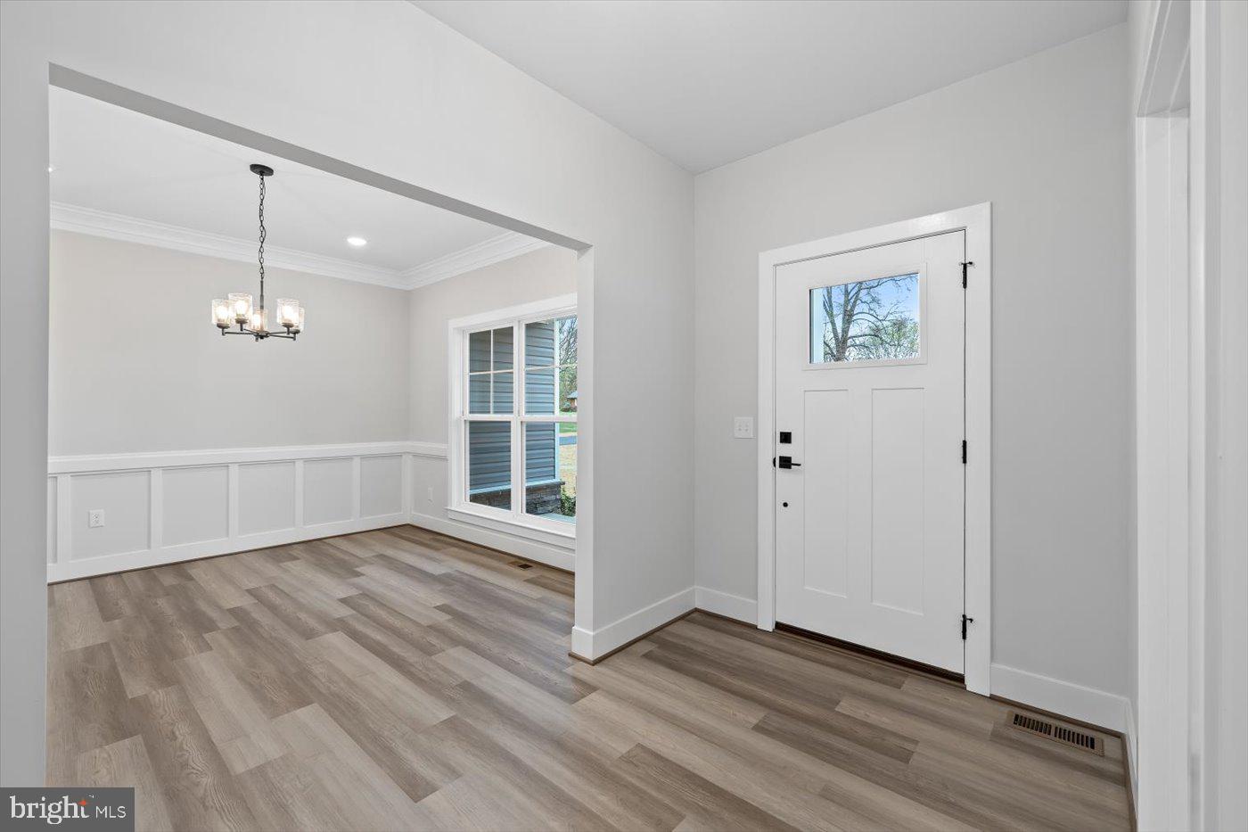 0 Stevensburg Road Culpeper, VA 22701 - Photo 9 of 42 an empty room with wooden floor chandelier and windows