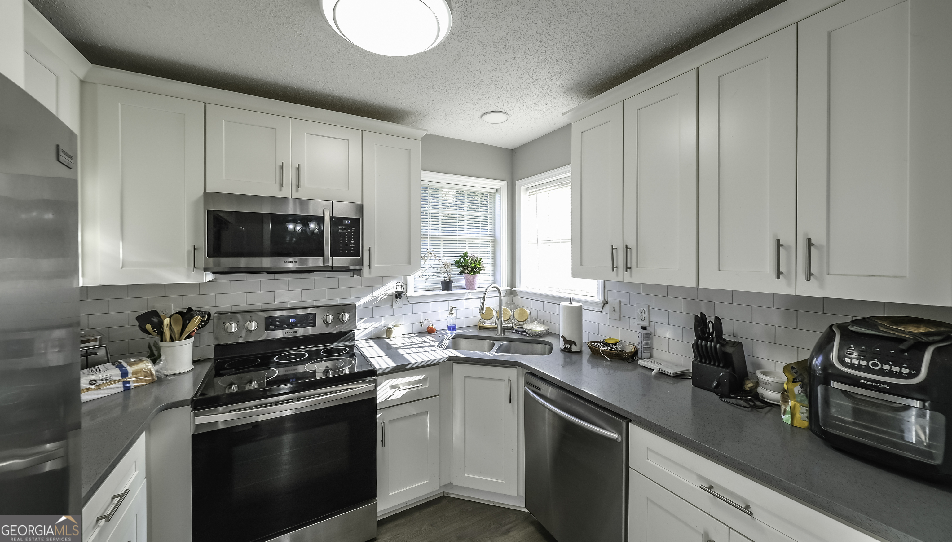 85 Taylors Gin Road Temple, GA 30179 - Photo 18 of 45 a kitchen with stainless steel appliances granite countertop a sink a stove a microwave and cabinets