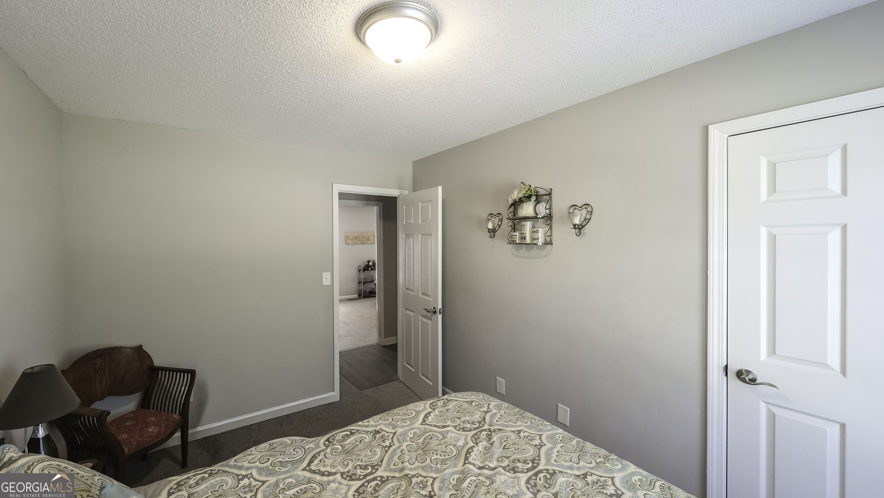 85 Taylors Gin Road Temple, GA 30179 - Photo 23 of 45 a bedroom with a bed and wooden floor