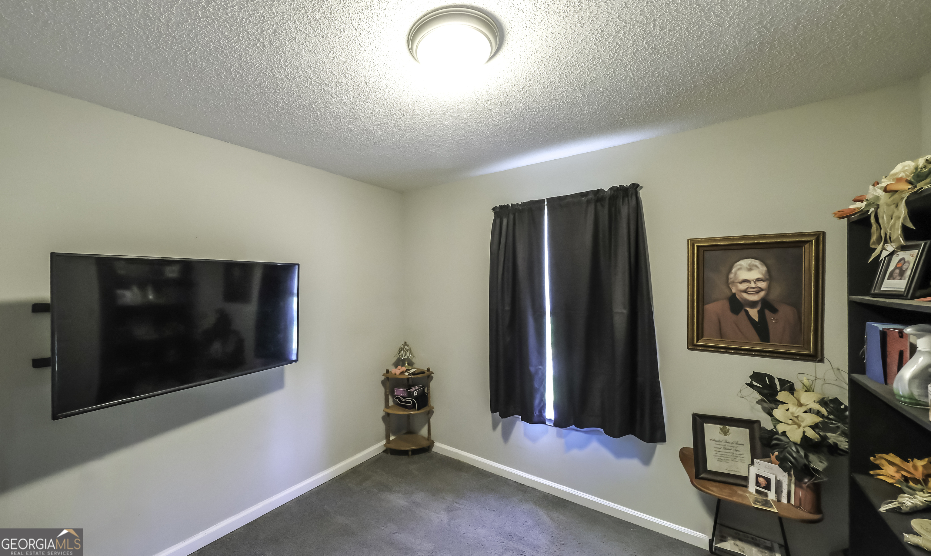 85 Taylors Gin Road Temple, GA 30179 - Photo 27 of 45 a living room with furniture and a flat screen tv