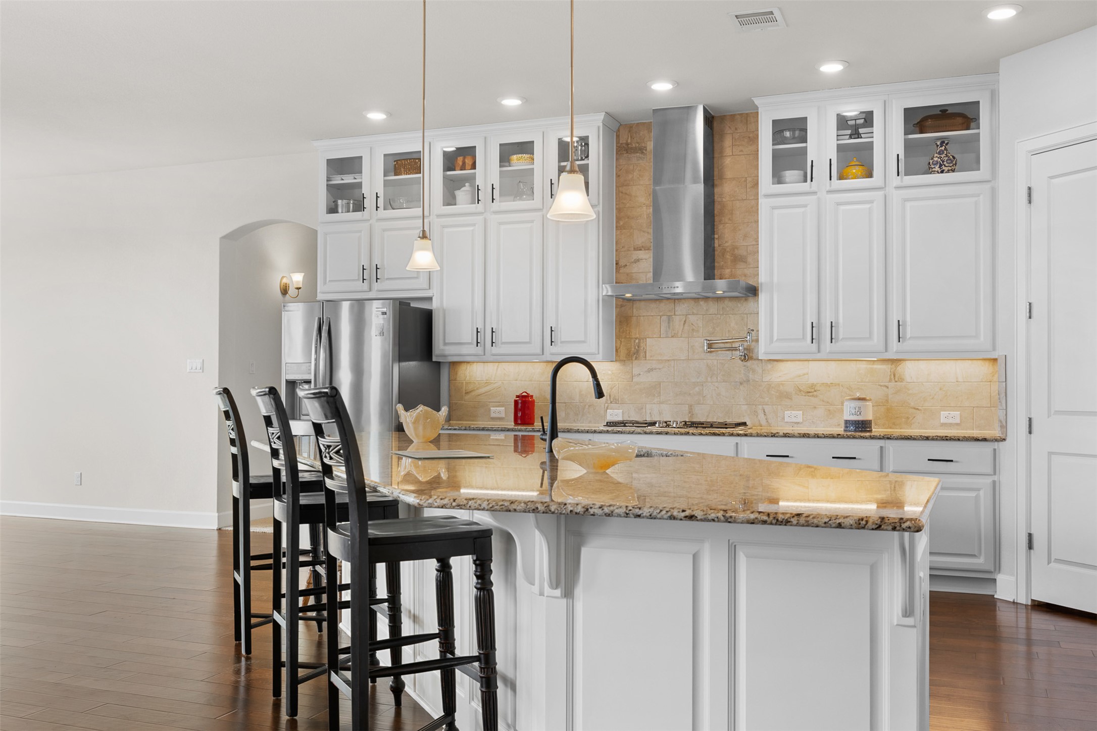 235 Chestnut Crossing Burnet, TX 78611 - Photo 18 of 39 a kitchen with stainless steel appliances granite countertop a table chairs sink and cabinets
