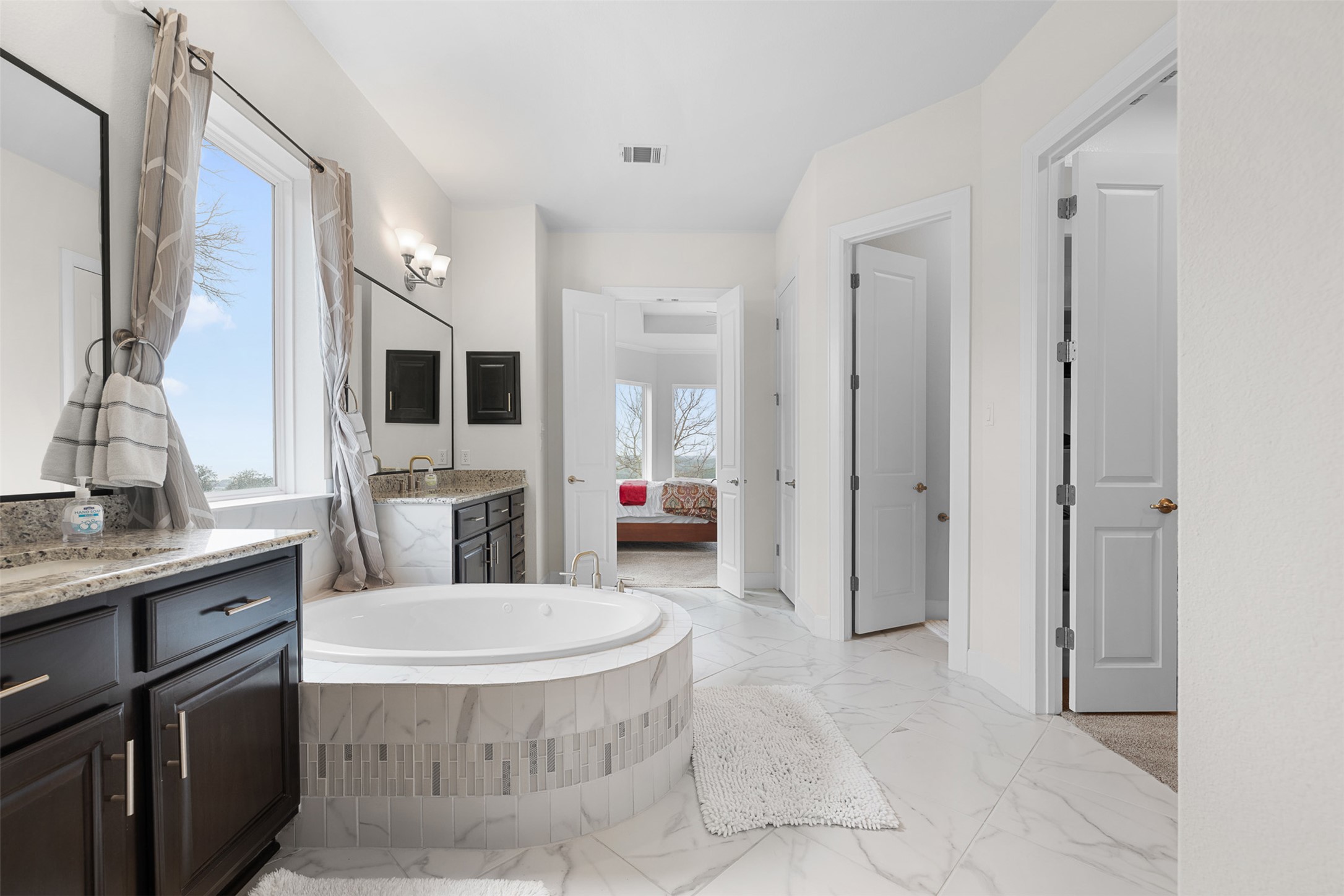 235 Chestnut Crossing Burnet, TX 78611 - Photo 22 of 39 a spacious bathroom with a granite countertop sink toilet and shower
