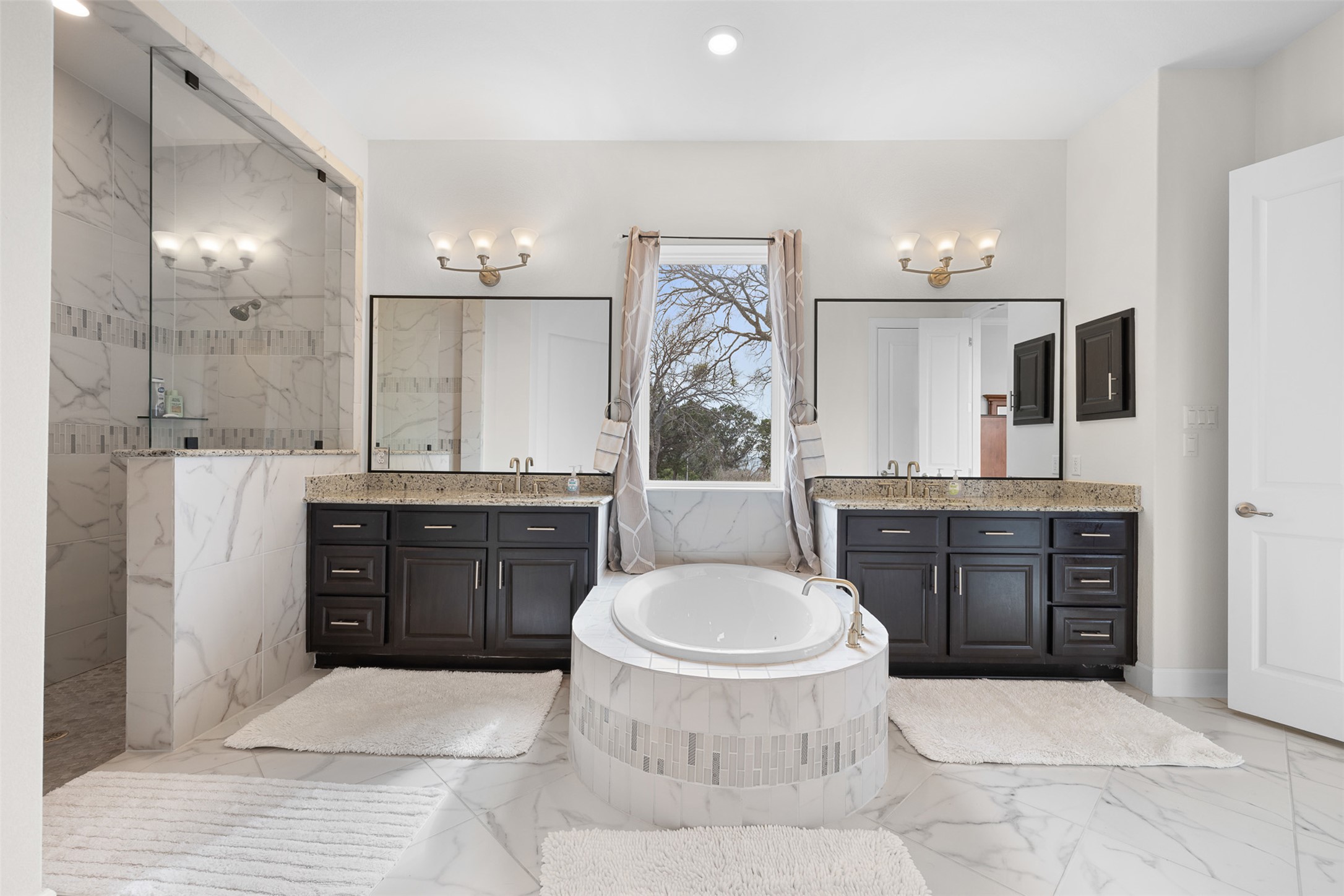 235 Chestnut Crossing Burnet, TX 78611 - Photo 22 of 39 a bathroom with a granite countertop toilet sink and mirror