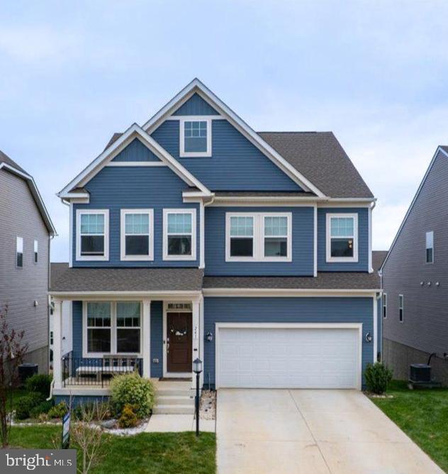 Charming blue home with inviting porch.