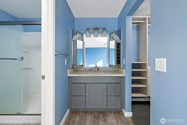 a bathroom with a granite countertop sink and a mirror
