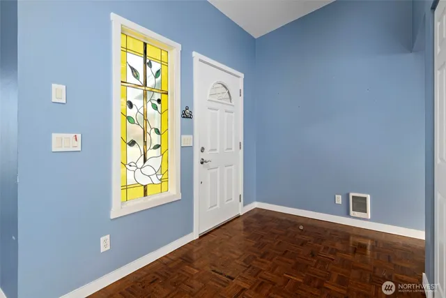 a view of an entryway with wooden floor and a window