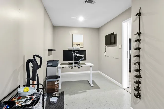 a view of a workspace with furniture and a flat screen tv
