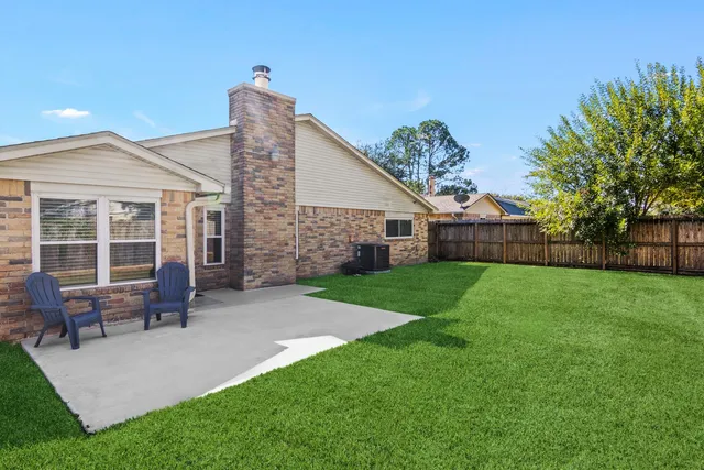 a view of a house with backyard and a sitting area