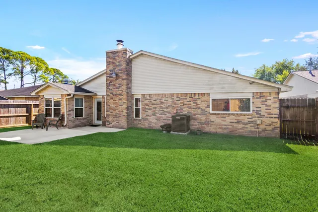a front view of a house with a garden and yard