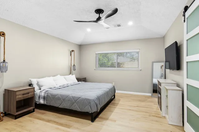 a bedroom with a bed and a flat screen tv