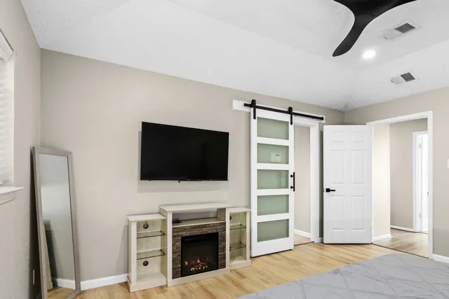 a view of living room with flat screen tv and refrigerator