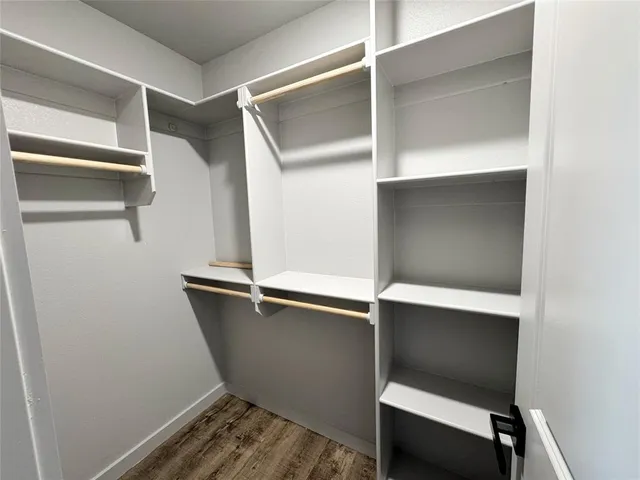 an empty room with closet and windows