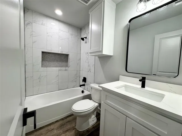 a kitchen with stainless steel appliances granite countertop a stove and a refrigerator