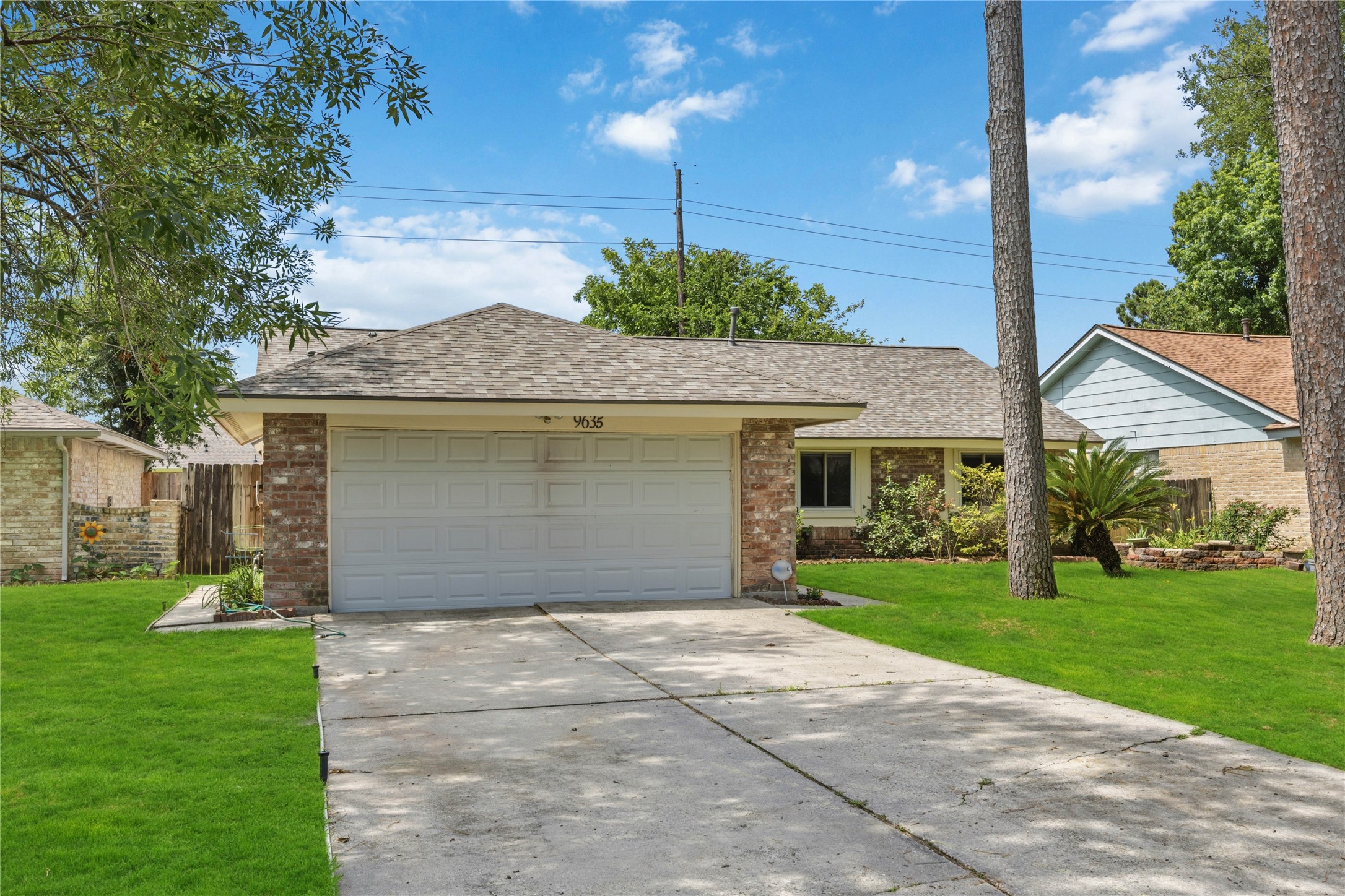 9635 Birsay Street Spring, TX 77379 - Photo 3 of 24 a front view of a house with a yard and garage