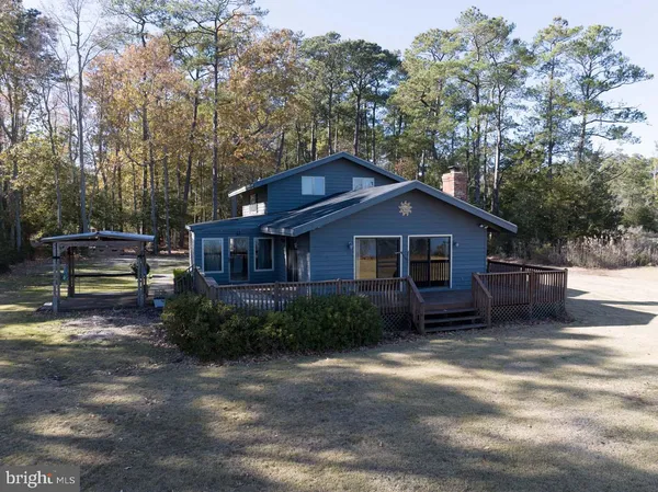 an aerial view of a houses with a lake