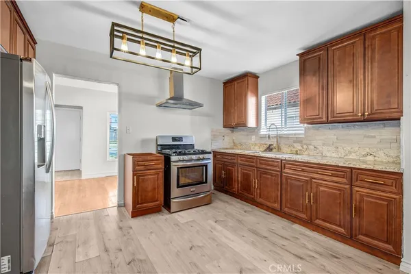 a kitchen with stainless steel appliances granite countertop a stove and a sink