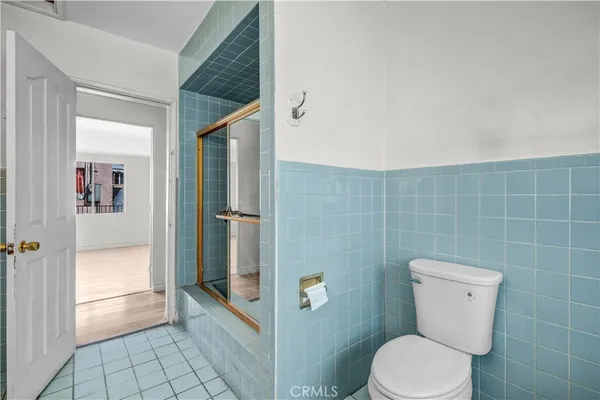 a bathroom with a toilet and a shower