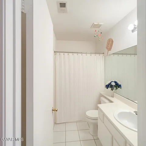 a bathroom with a sink vanity and mirror