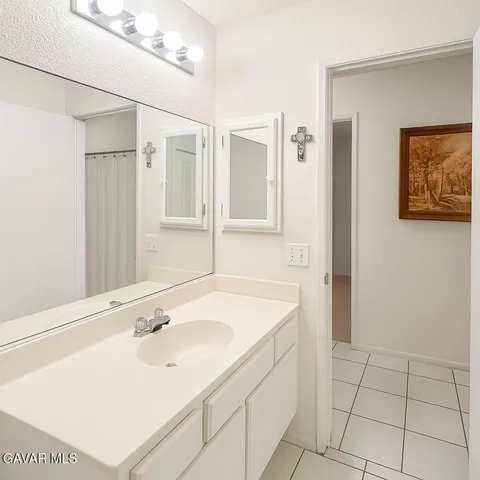 a roof deck with table and chairs under an umbrella