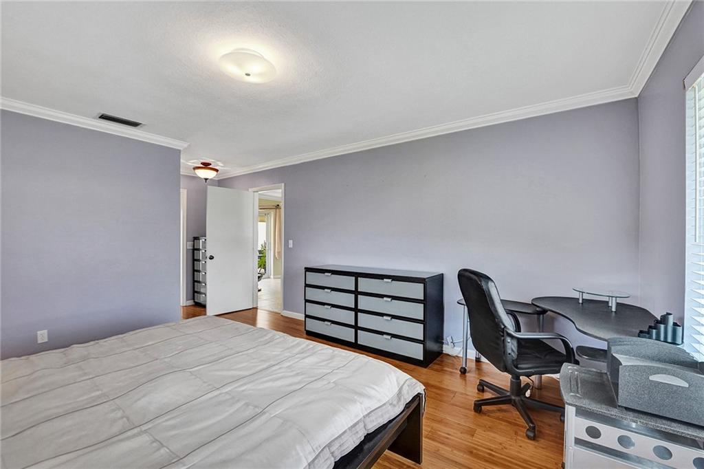 5760 Southwest 7th Street Plantation, FL 33317 - Photo 23 of 56 a bedroom with a bed and a desk