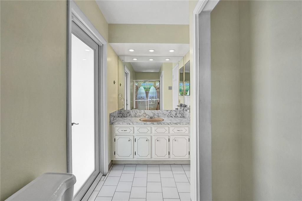 5760 Southwest 7th Street Plantation, FL 33317 - Photo 28 of 56 a bathroom with a granite countertop sink a toilet and a mirror