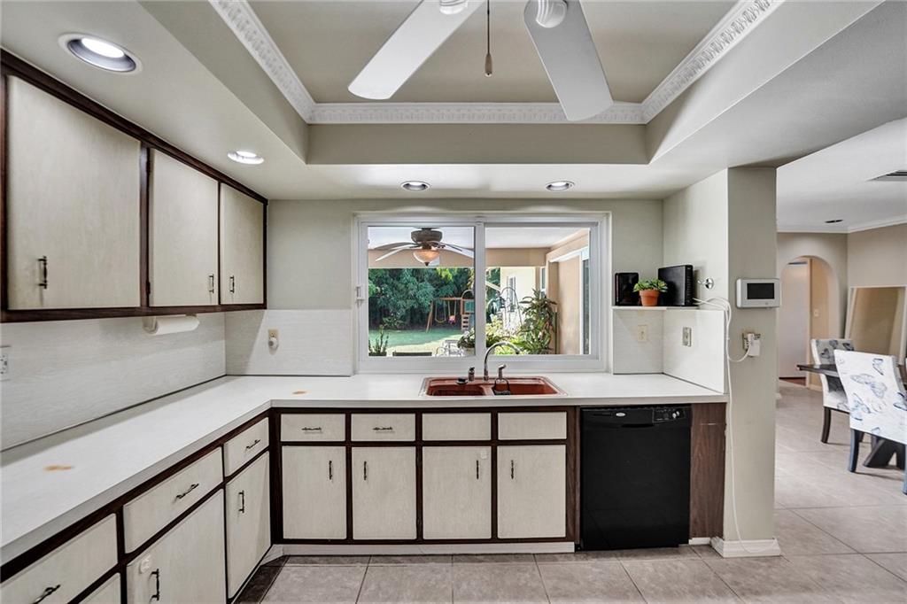 5760 Southwest 7th Street Plantation, FL 33317 - Photo 30 of 56 a kitchen with stainless steel appliances kitchen island granite countertop a sink and cabinets