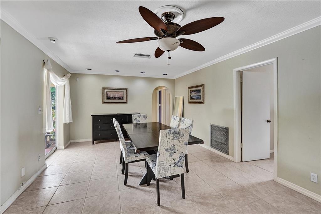 5760 Southwest 7th Street Plantation, FL 33317 - Photo 33 of 56 a dining room with furniture and a ceiling fan