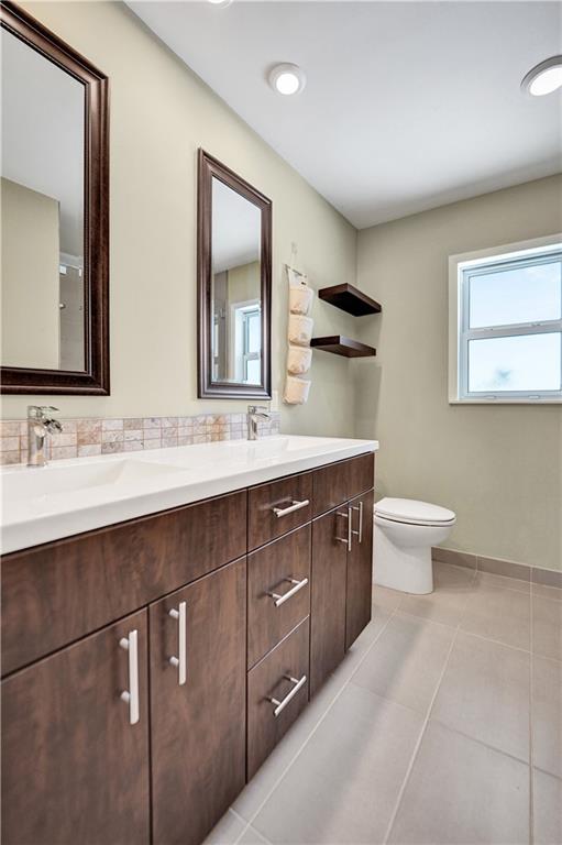 5760 Southwest 7th Street Plantation, FL 33317 - Photo 39 of 56 a bathroom with a double vanity sink and a mirror