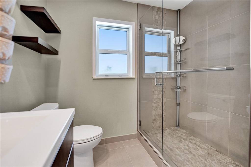 5760 Southwest 7th Street Plantation, FL 33317 - Photo 41 of 56 a white toilet sitting next to a bathroom sink