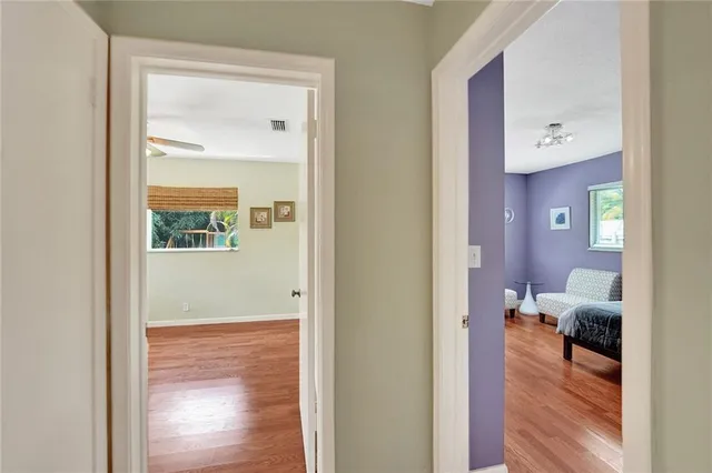 a view of empty room with wooden floor