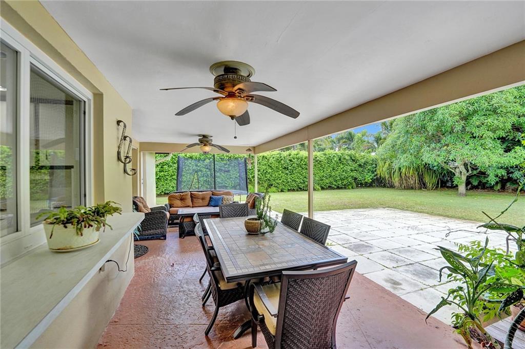 5760 Southwest 7th Street Plantation, FL 33317 - Photo 49 of 56 a view of a patio with a table chairs and a backyard