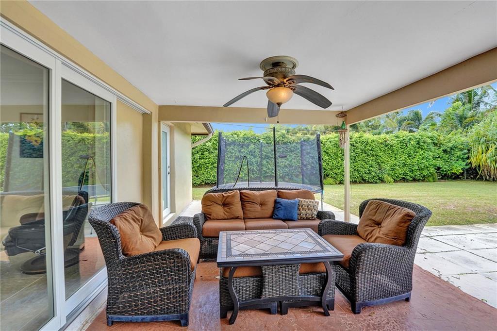 5760 Southwest 7th Street Plantation, FL 33317 - Photo 50 of 56 a outdoor space with patio the couches and a dining table with garden view